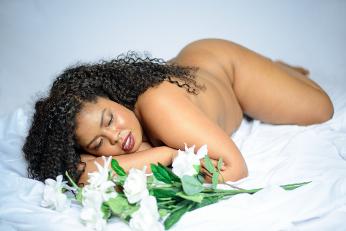 Large woman in bed with flowers