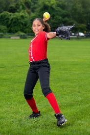 young girl throwing softball