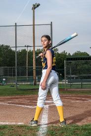 softball player holding bat on shoulder