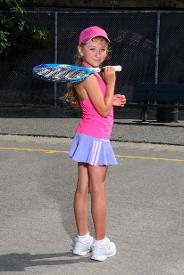 little girl wearing tennis outfit