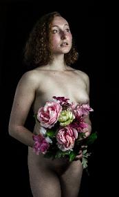 nude low key woman with flowers